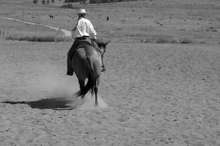 3. As we continue in our right circle, this shows my right leg back, and you can clearly see how my weight is shifted to the left. I like to feel as though I'm sitting slightly forward and over the outside shoulder.