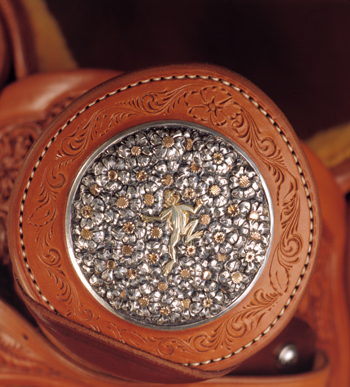 On this horn cap Scott Hardy created for a Cary Schwarz saddle, a 14-karat green gold frog travels across a bed of silver and gold wildflowers. The saddle appeared in the 2000 TCAA exhibition. PHOTO COURTESY NATIONAL COWBOY & WESTERN HERITAGE MUSEUM 